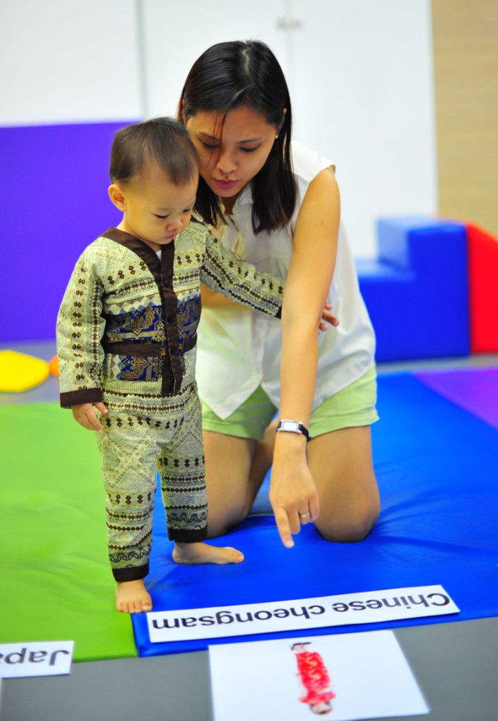 Our last lesson at Gymnademics coincided with Racial Harmony Day and Nat got to wear ethnic Indon garb! Here he is learning about traditional costumes!