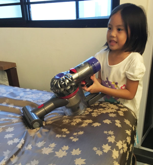 I found her quietly engaged in pretend play one evening in the guise of cleaning the bed