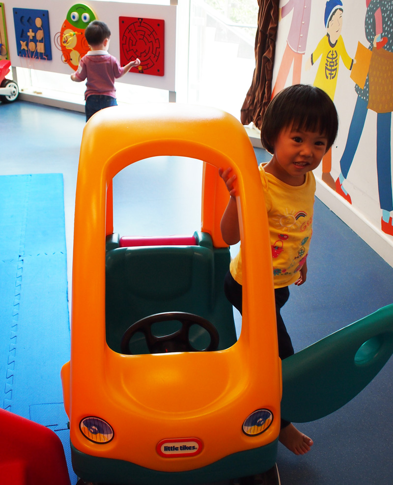 Getting around in her Little Tike before class