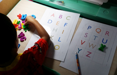 I made this for Nat and he likes doing this (but never gets past more than 10 letters) - this is a matching activity using magnetic letters and a laminated paper letter chart