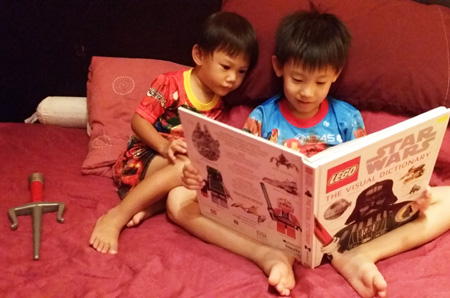 The boys sharing a moment together exploring a book, which happened all so suddenly. Moments before that they were swordfighting!